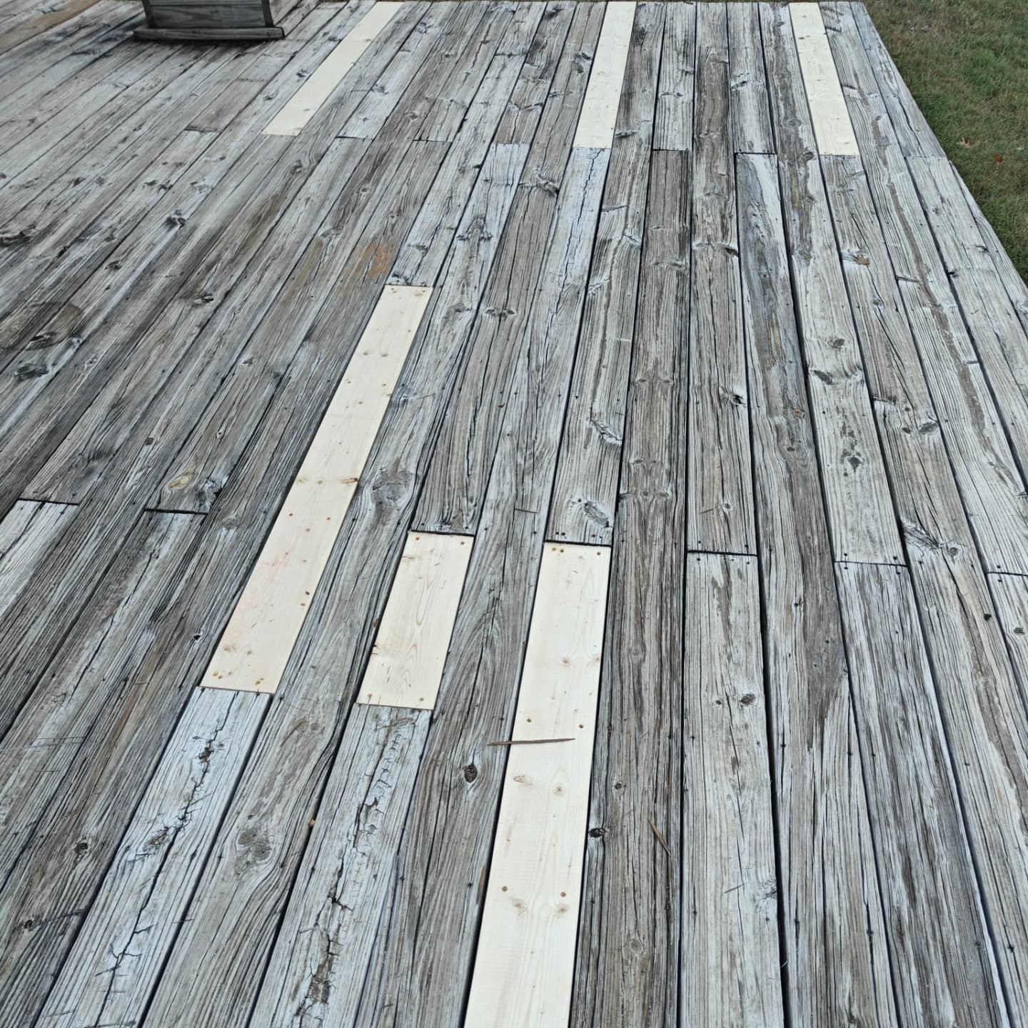 New deck boards fastened in by Curb Appeal, the surface flat and even again