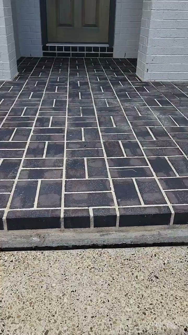 Curb Appeal brick paver porch and front door after a power wash, the pavers dark and even